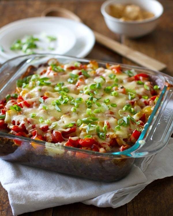 Quinoa and black bean casserole in a clear baking dish.