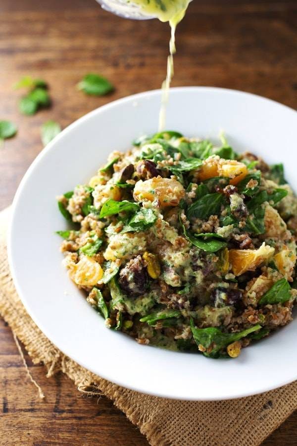Moroccan Salad with Cilantro Orange Dressing drizzle in a white bowl.