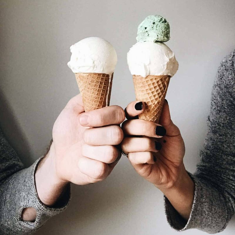 Lindsay and Bjork holding ice cream cones.