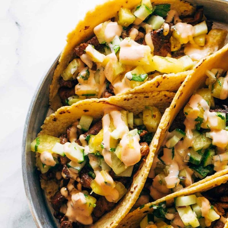 A picture of Caramelized Pork Tacos with Pineapple Salsa