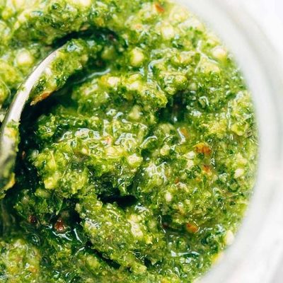 Kale Pesto in a jar with spoon.