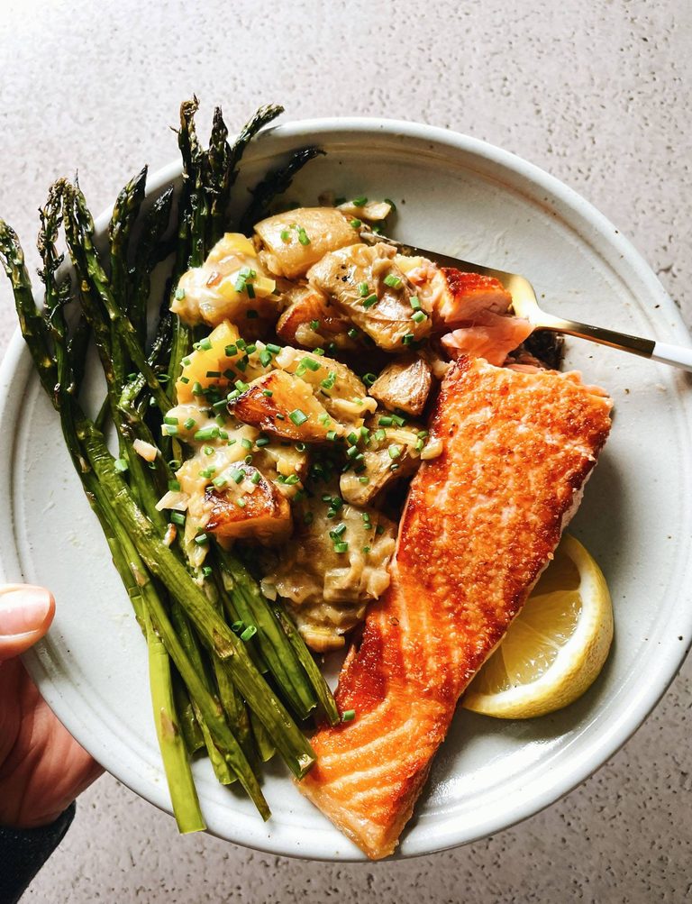 Salmon on a plate with potatoes and asparagus.
